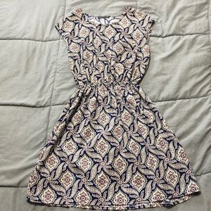 A navy blue, tan, purple, pink patterned dress